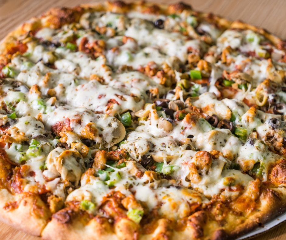 The QC Garbage Pizza - On our signature crust we add house red sauce, house sausage, Italian sausage, regular pepperoni, onions, house sauteed mushrooms, green peppers, onions, green and black olives. Limited half-n-half options. Please allow longer cooking time due to the amounts of meat & veggies we add! Available on 12-inch and 16-inch house crust or gluten-free cauliflower crust.