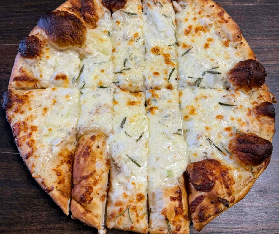 On our signature crust we add Ken’s White Garlic Pizza Sauce as the base, onions, white meat chicken, house-blend mozzarella, and fresh rosemary. 12-inch medium size only.